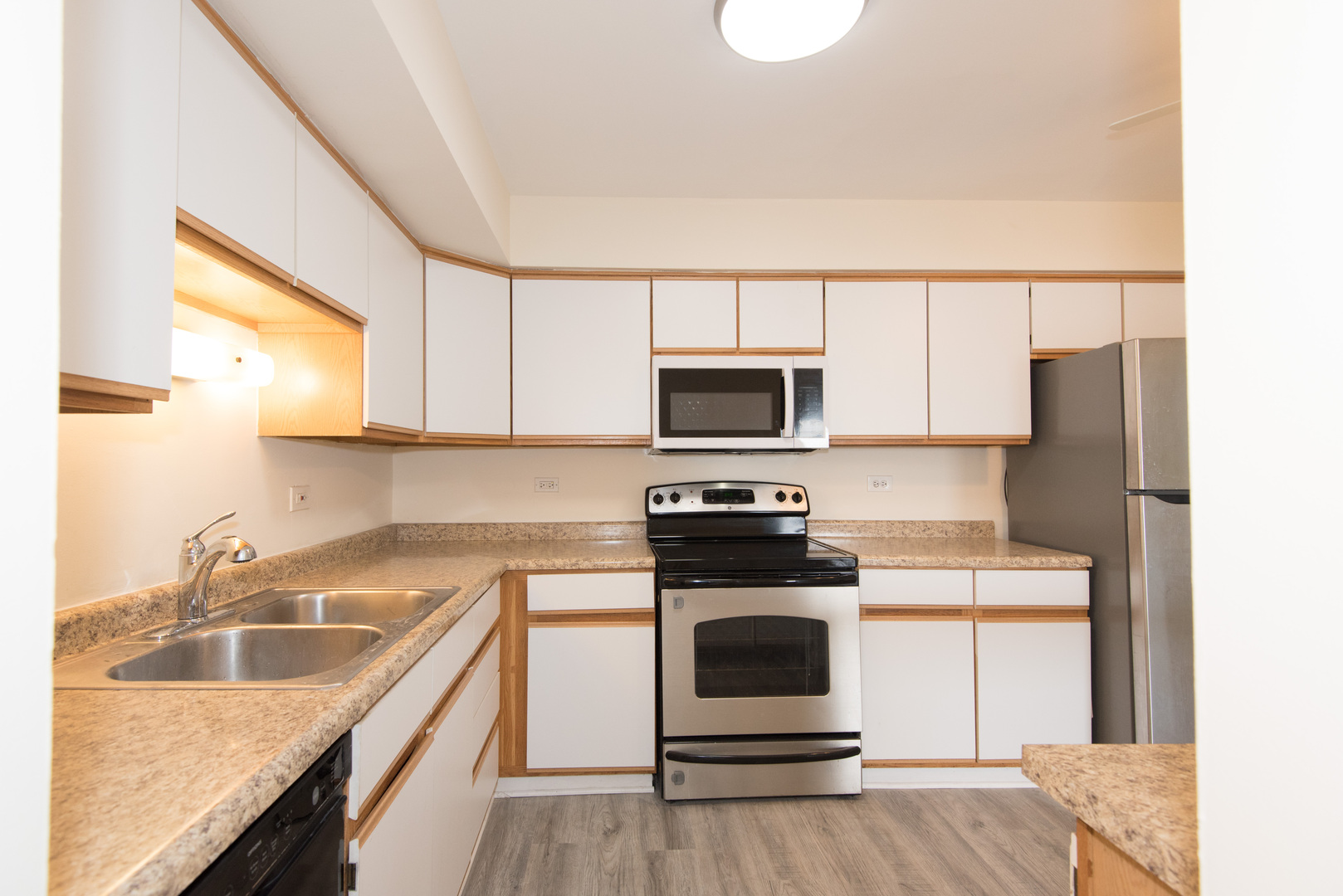 2218 South Goebbert Road, Unit 487 Arlington Heights, IL 60005 - Photo 10 of 23 a kitchen with a sink appliances and cabinets