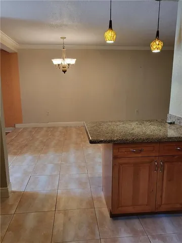 a kitchen with a cabinets and chandelier