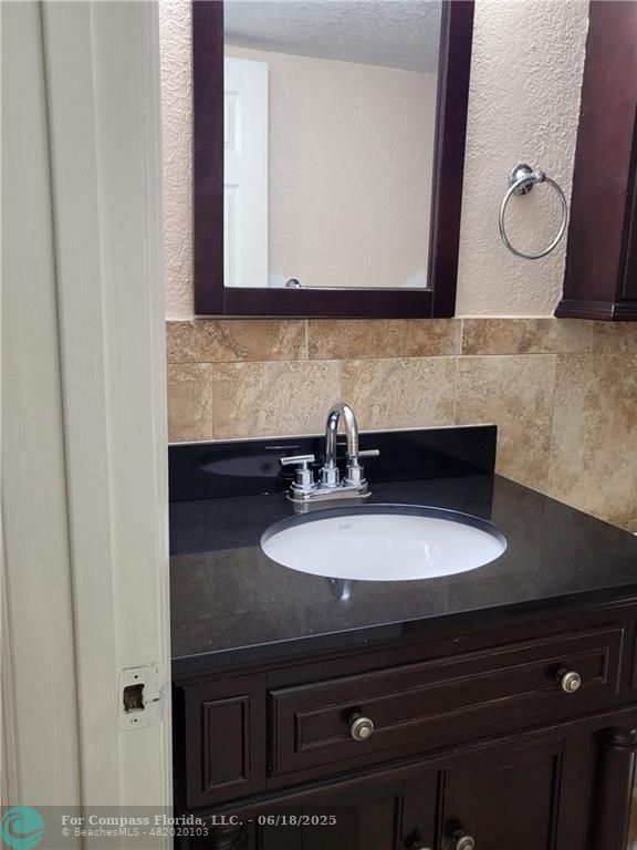780 Northeast 199th Street, Unit E 101 Miami, FL 33179 - Photo 13 of 34 a bathroom with a sink and a mirror