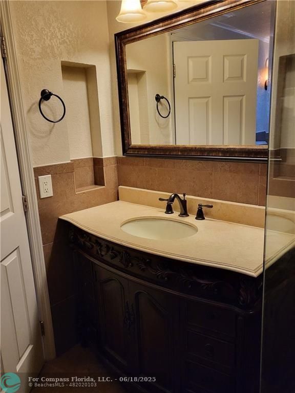 780 Northeast 199th Street, Unit E 101 Miami, FL 33179 - Photo 16 of 34 a bathroom with a sink and a mirror