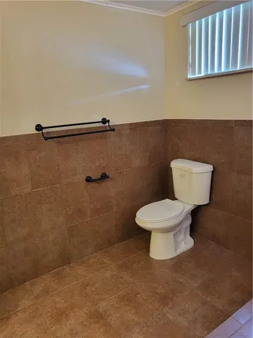 a white toilet sitting next to a bathroom sink