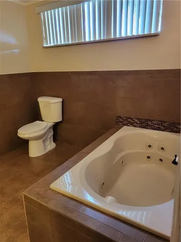 a bathroom with a bathtub and toilet