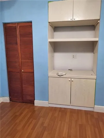 a view of an empty room with cabinet