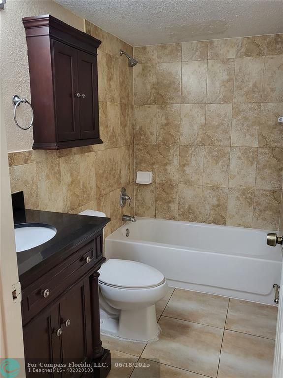 780 Northeast 199th Street, Unit E 101 Miami, FL 33179 - Photo 23 of 34 a bathroom with a sink a toilet and bathtub