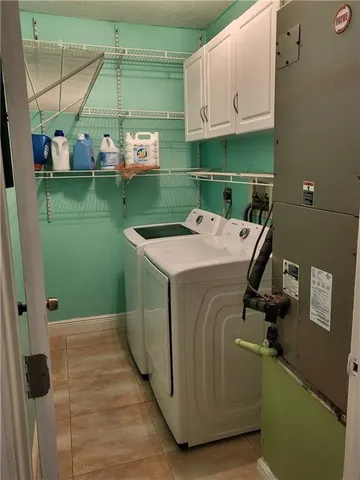 a utility room with a washing machine and a sink
