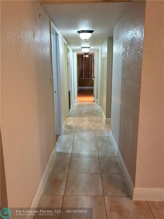 780 Northeast 199th Street, Unit E 101 Miami, FL 33179 - Photo 25 of 34 a view of hallway