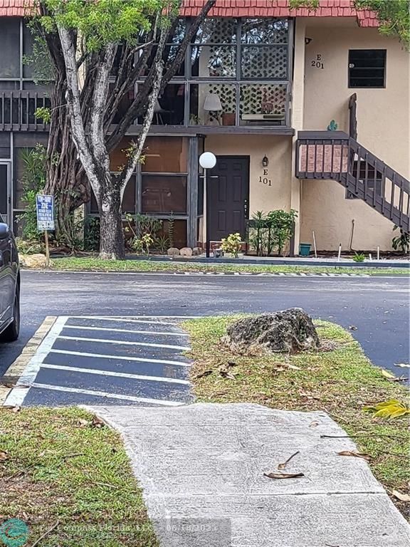 780 Northeast 199th Street, Unit E 101 Miami, FL 33179 - Photo 3 of 34 front view of a house with a yard
