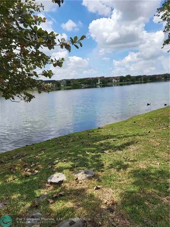 780 Northeast 199th Street, Unit E 101 Miami, FL 33179 - Photo 33 of 34 a view of a lake from a yard
