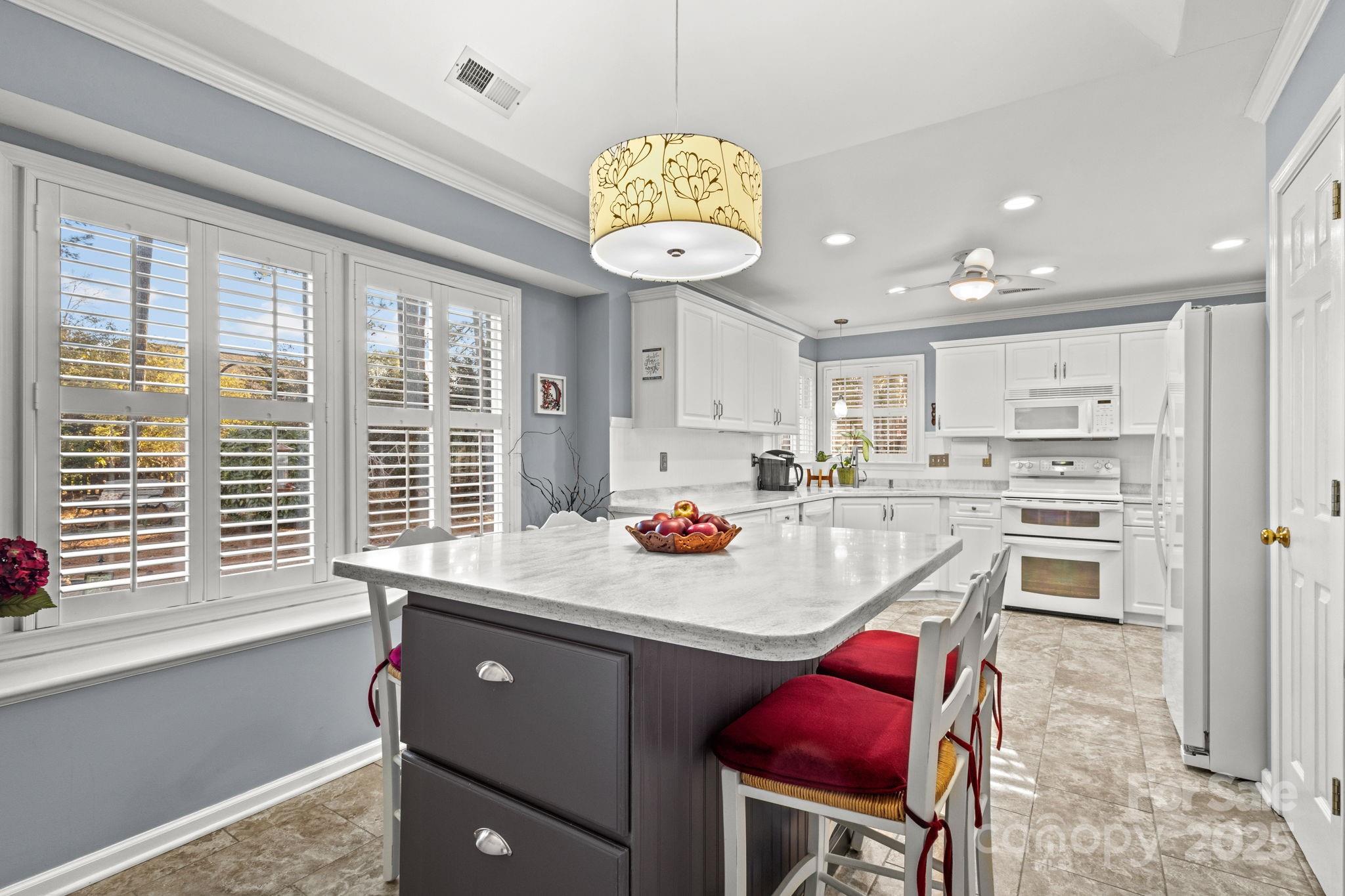 227 Point Wylie Lane Fort Mill, SC 29708 - Photo 12 of 36 a kitchen with stainless steel appliances granite countertop a sink a stove and a refrigerator