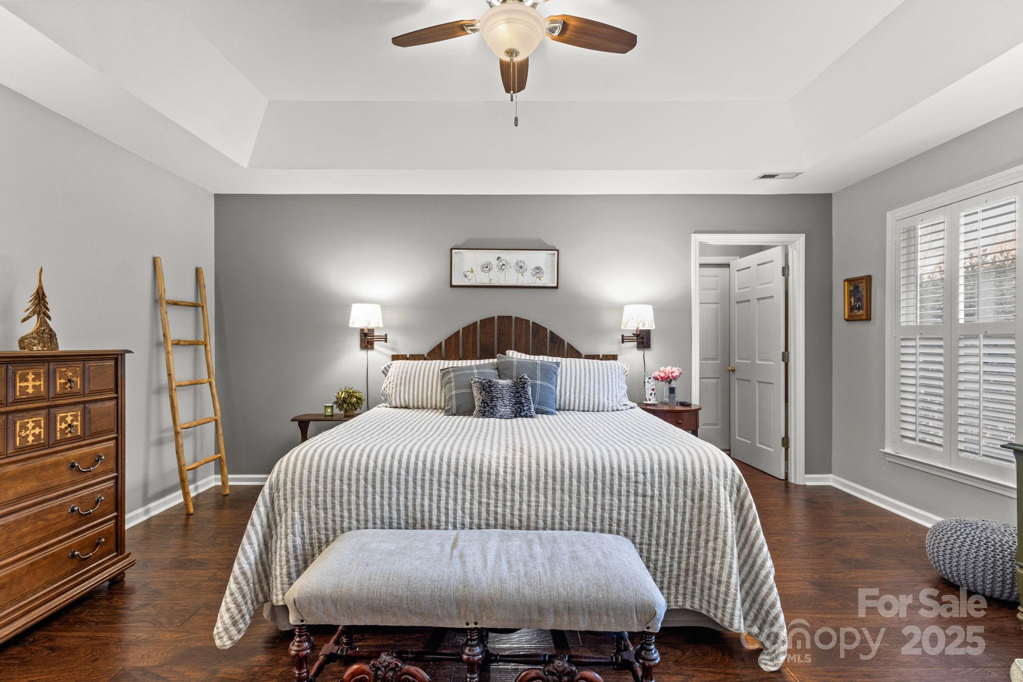 227 Point Wylie Lane Fort Mill, SC 29708 - Photo 17 of 36 a bedroom with a bed and a chandelier
