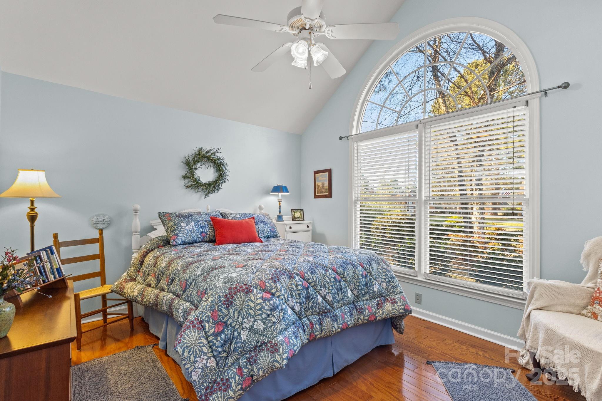 227 Point Wylie Lane Fort Mill, SC 29708 - Photo 24 of 36 a bedroom with a bed and a chandelier
