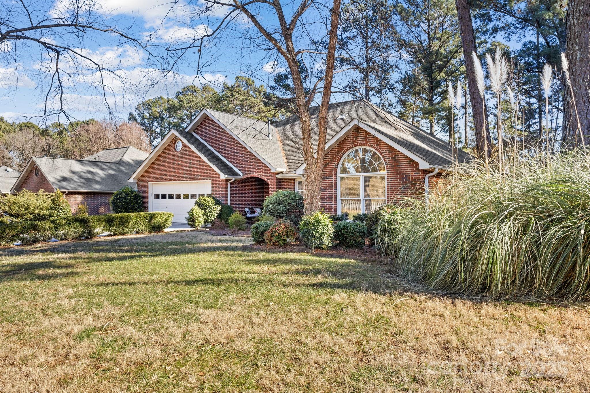 227 Point Wylie Lane Fort Mill, SC 29708 - Photo 3 of 36 a front view of a house with a garden
