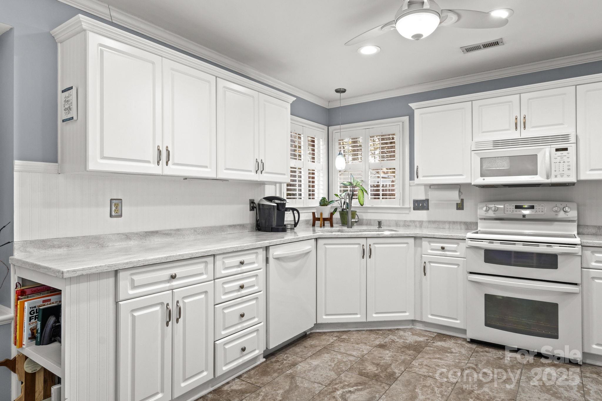 227 Point Wylie Lane Fort Mill, SC 29708 - Photo 10 of 36 a kitchen with white cabinets and white appliances