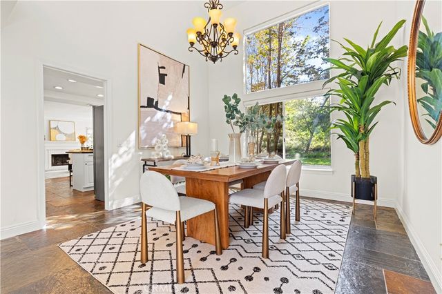 a living room with fireplace furniture and a large window