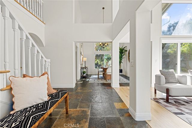 a living room with furniture a fireplace and a chandelier