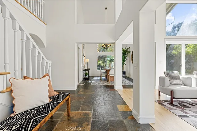 a living room with furniture a fireplace and a chandelier