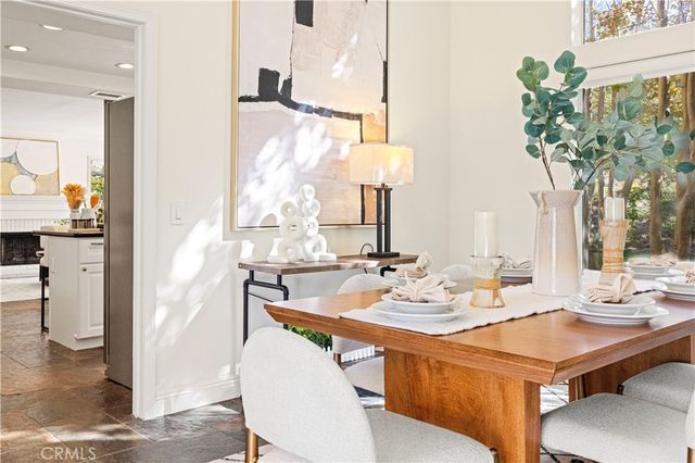 a dining room with furniture and wooden floor