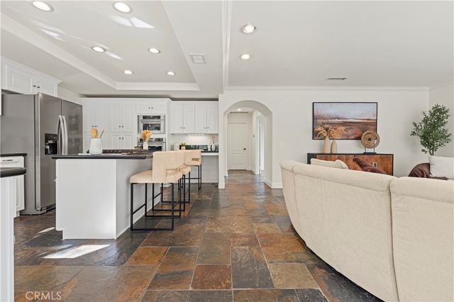 a living room with furniture a counter space and stainless steel appliances
