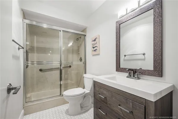 a bathroom with a sink toilet and shower