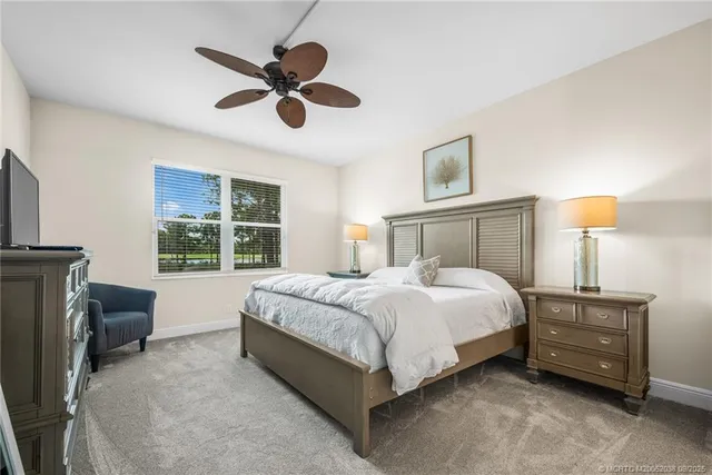 a bedroom with a bed dresser and a window