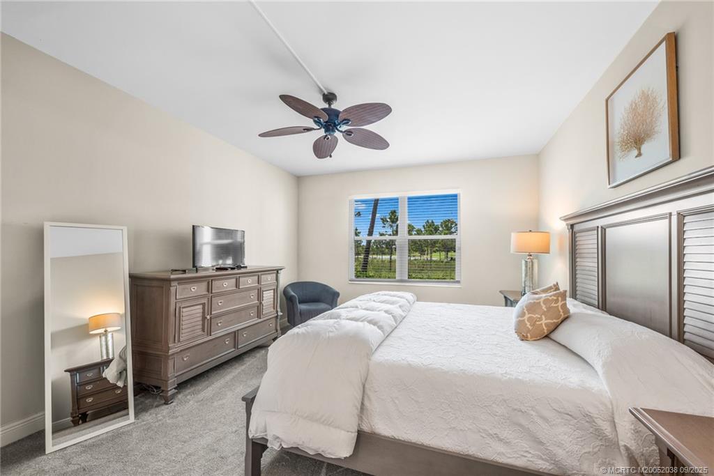 13226 Harbour Ridge Boulevard, Unit 5B Palm City, FL 34990 - Photo 17 of 28 a bedroom with a bed and a chandelier