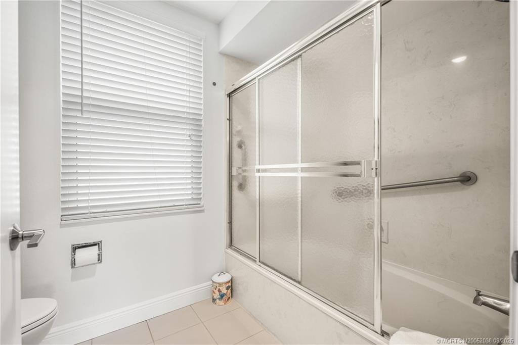 13226 Harbour Ridge Boulevard, Unit 5B Palm City, FL 34990 - Photo 19 of 28 a bathroom with a shower and a toilet