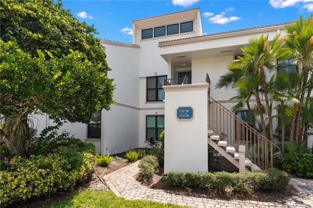 13226 Harbour Ridge Boulevard, Unit 5B Palm City, FL 34990 - Photo 2 of 28 a front view of house with yard and green space