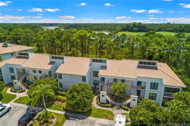 an aerial view of a house with garden space and outdoor seating