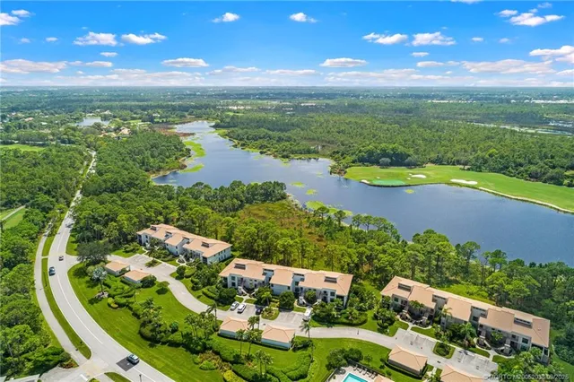 an aerial view of residential houses with outdoor space and river
