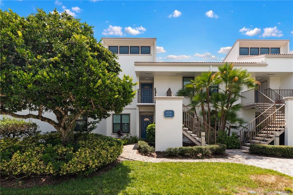 13226 Harbour Ridge Boulevard, Unit 5B Palm City, FL 34990 - Photo 28 of 28 a front view of a house with a yard