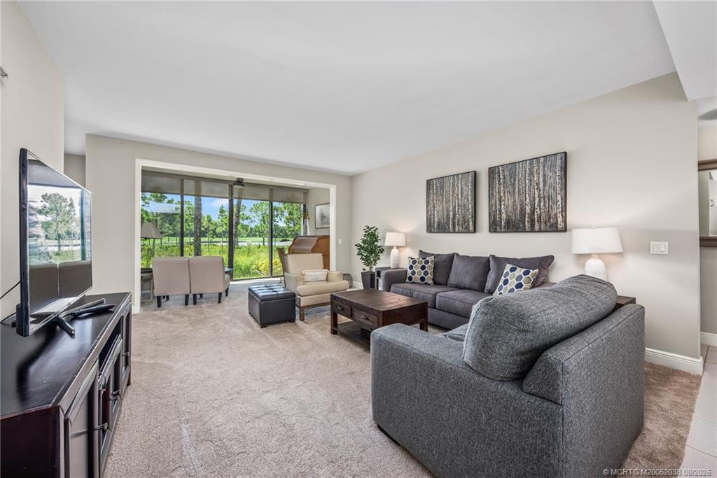 13226 Harbour Ridge Boulevard, Unit 5B Palm City, FL 34990 - Photo 6 of 28 a living room with furniture and a flat screen tv