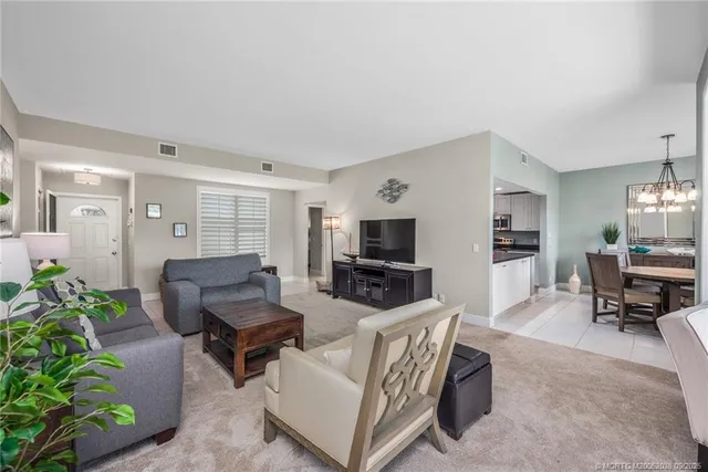 a living room with furniture a lamp and a flat screen tv