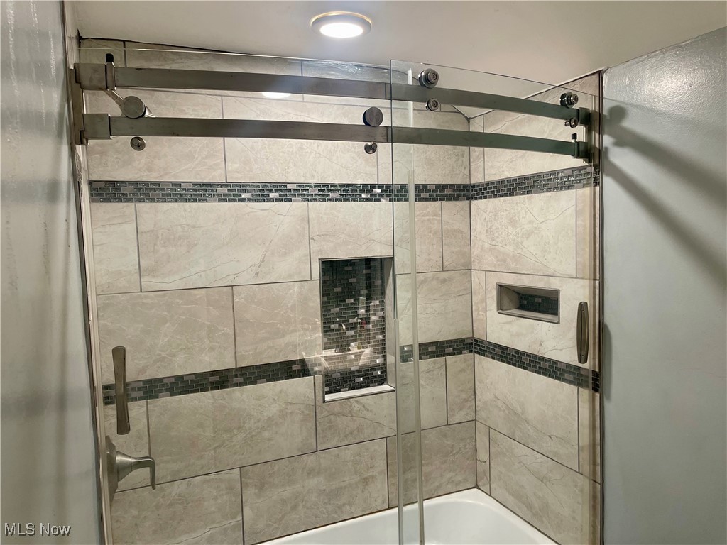 4241 Bluestone Road Cleveland, OH 44121 - Photo 22 of 31 Bathroom featuring shower / bath combination with glass door