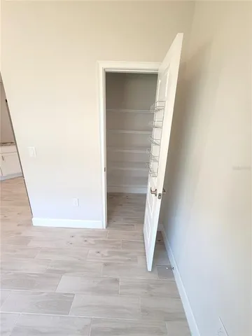 a view of staircase with white walls and white door