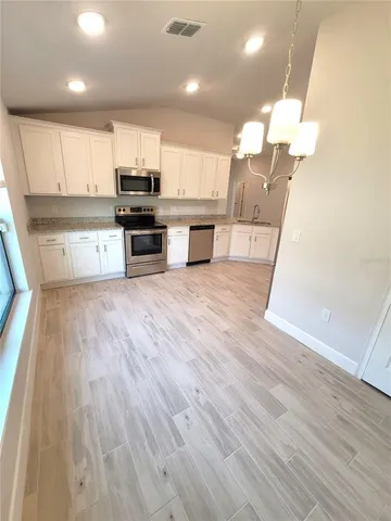 a view of kitchen with sink microwave and stove