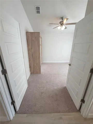 wooden floor in an empty room with a mirror