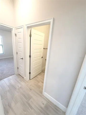 an empty room with wooden floor and white doors
