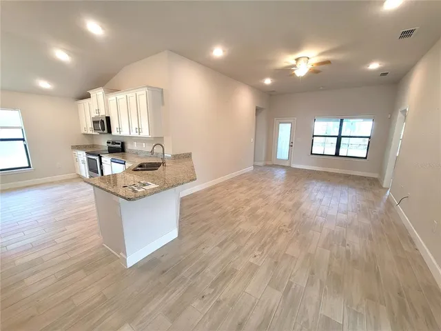 a large room with kitchen island lots of counter space