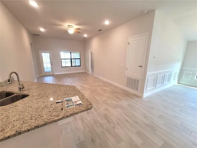 a view of a kitchen counter space and wooden floor