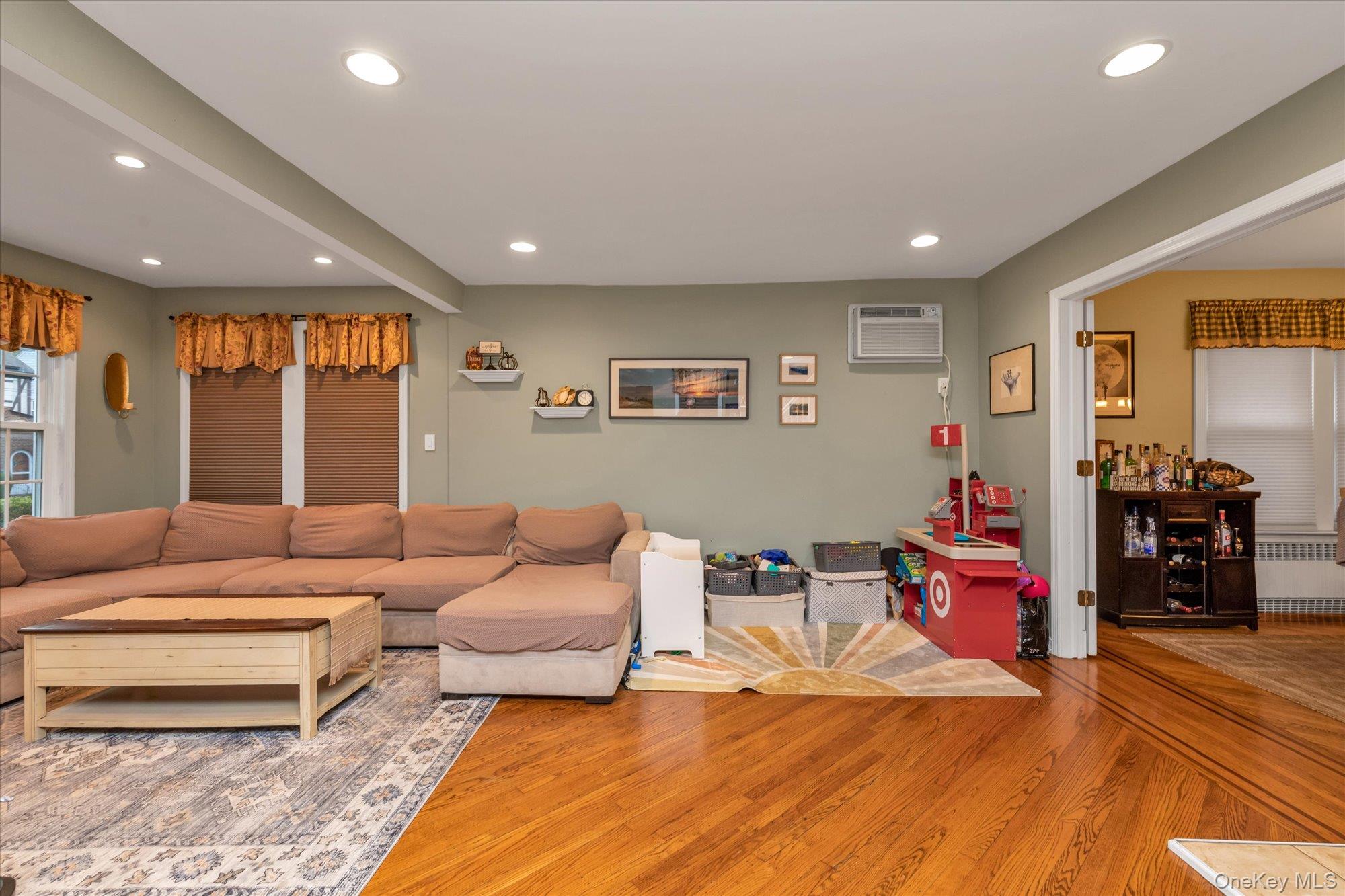 29 Orleans Road Valley Stream, NY 11581 - Photo 4 of 20 a living room with furniture and a flat screen tv