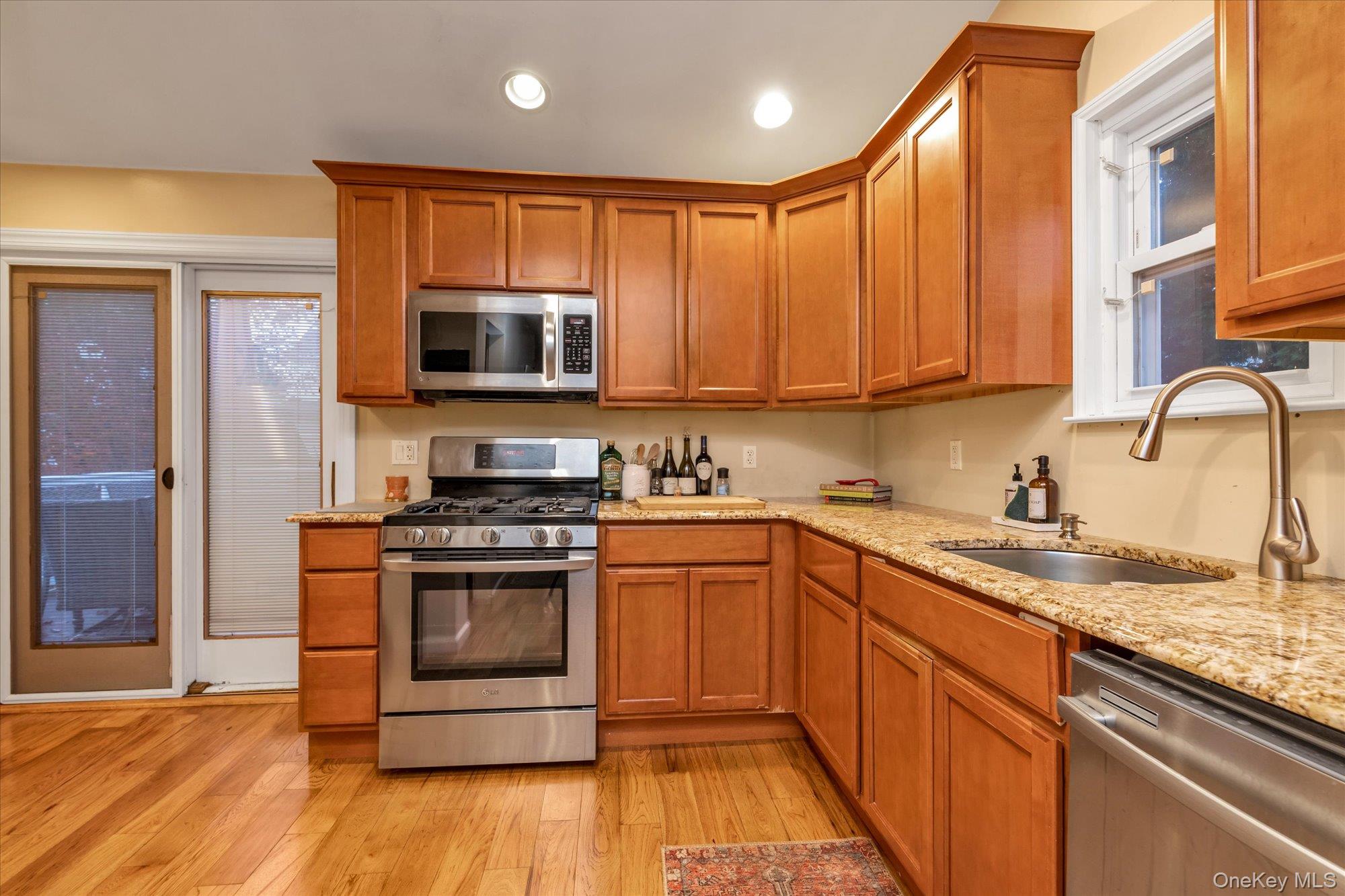 29 Orleans Road Valley Stream, NY 11581 - Photo 9 of 20 a kitchen with stainless steel appliances granite countertop a stove a sink and a microwave