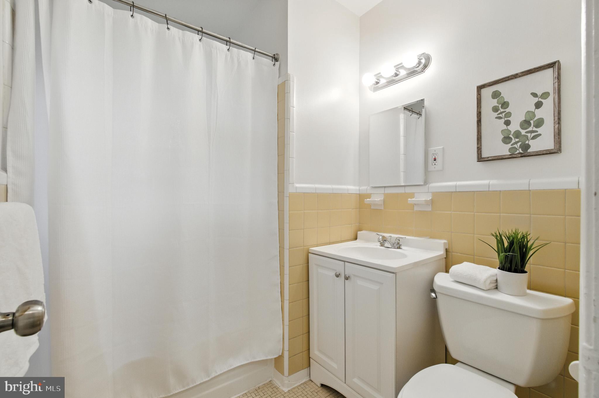 307 Plymouth Street Silver Spring, MD 20901 - Photo 22 of 44 a bathroom with a toilet a sink and a mirror