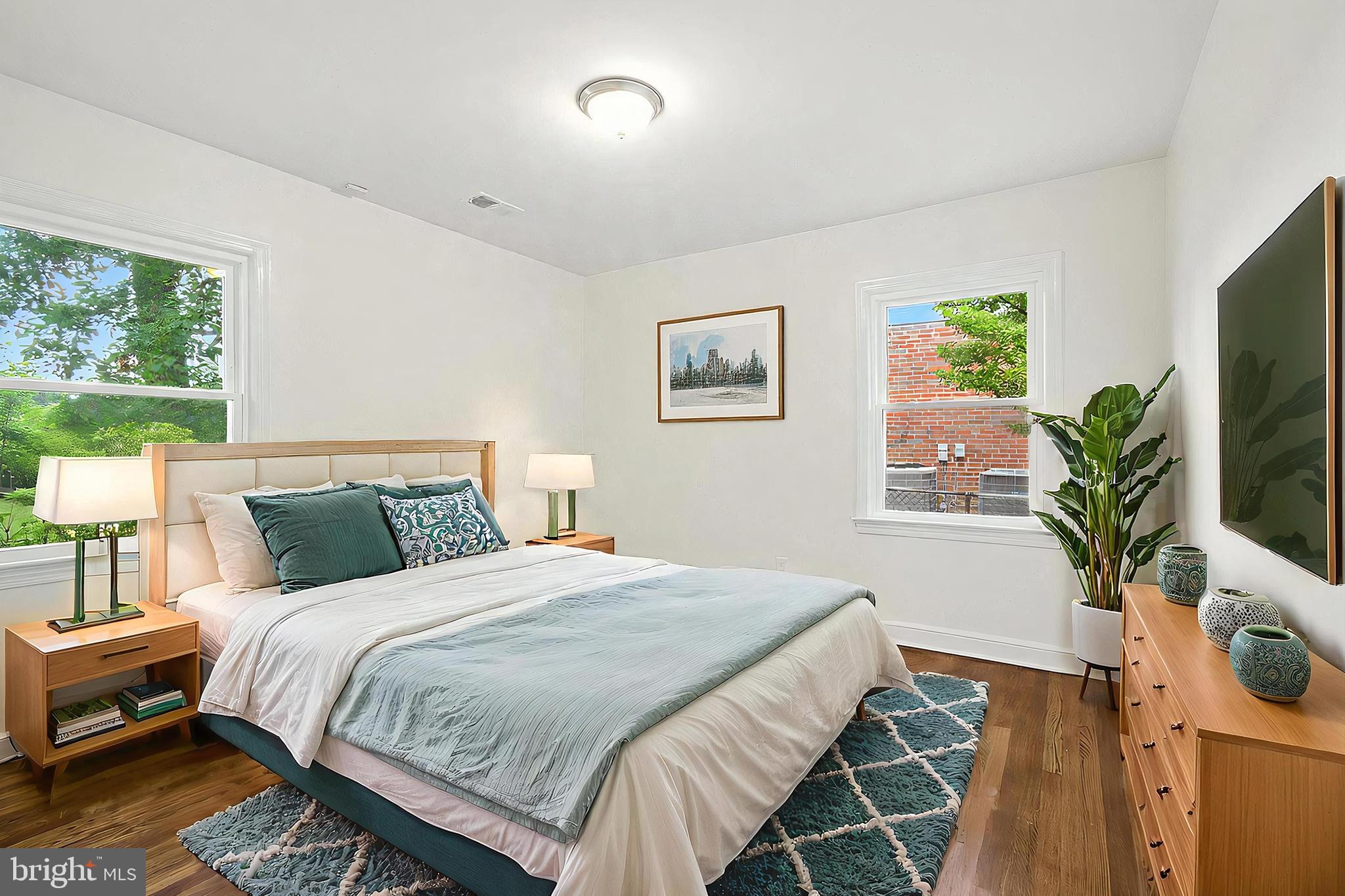 307 Plymouth Street Silver Spring, MD 20901 - Photo 23 of 44 a bedroom with a bed and a potted plant on the dresser