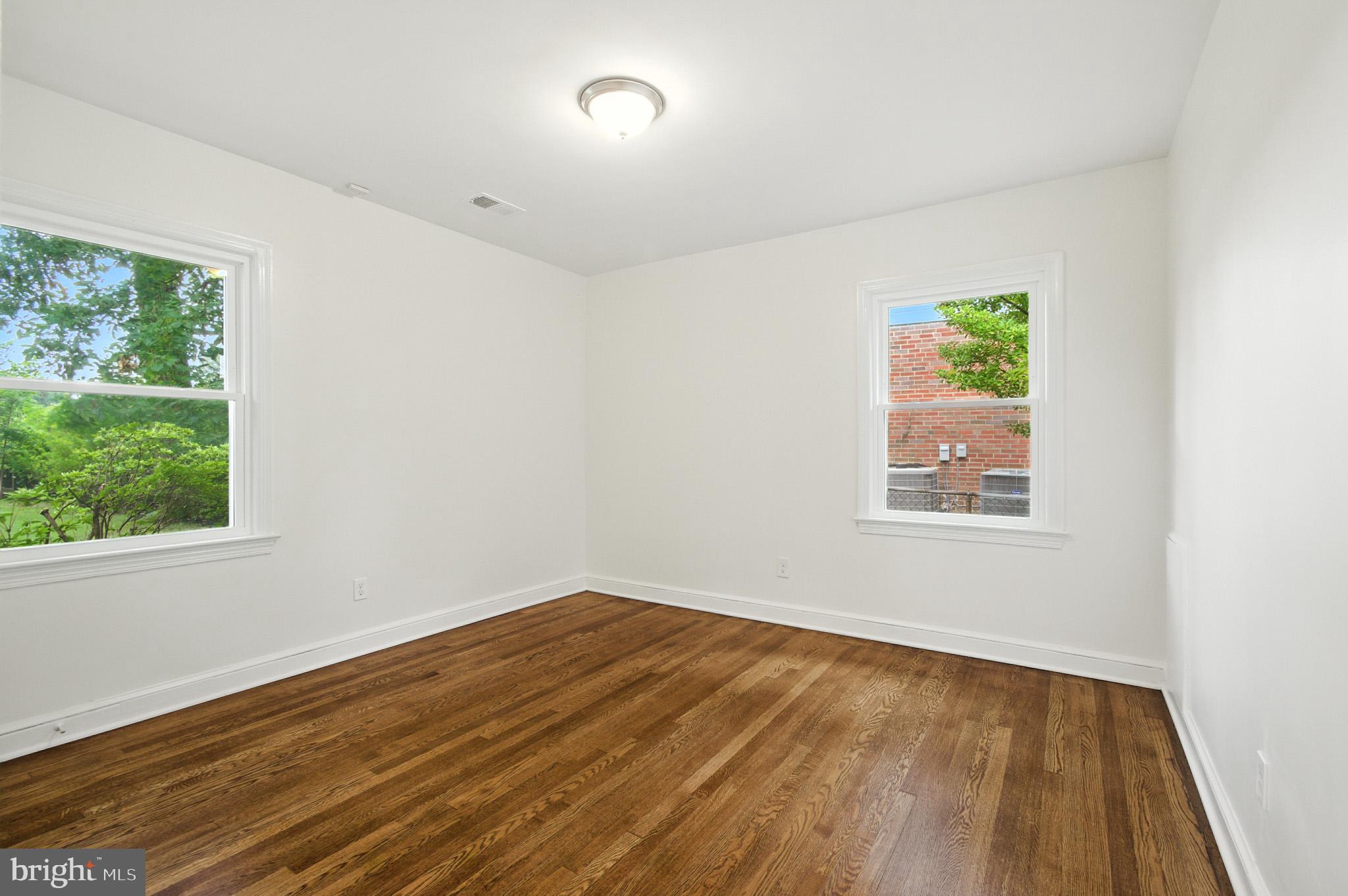 307 Plymouth Street Silver Spring, MD 20901 - Photo 24 of 44 a view of an empty room with wooden floor and a window