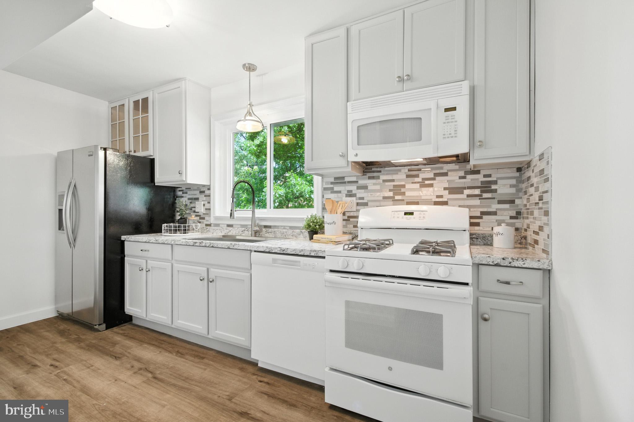 307 Plymouth Street Silver Spring, MD 20901 - Photo 35 of 44 a kitchen with white cabinets and white appliances