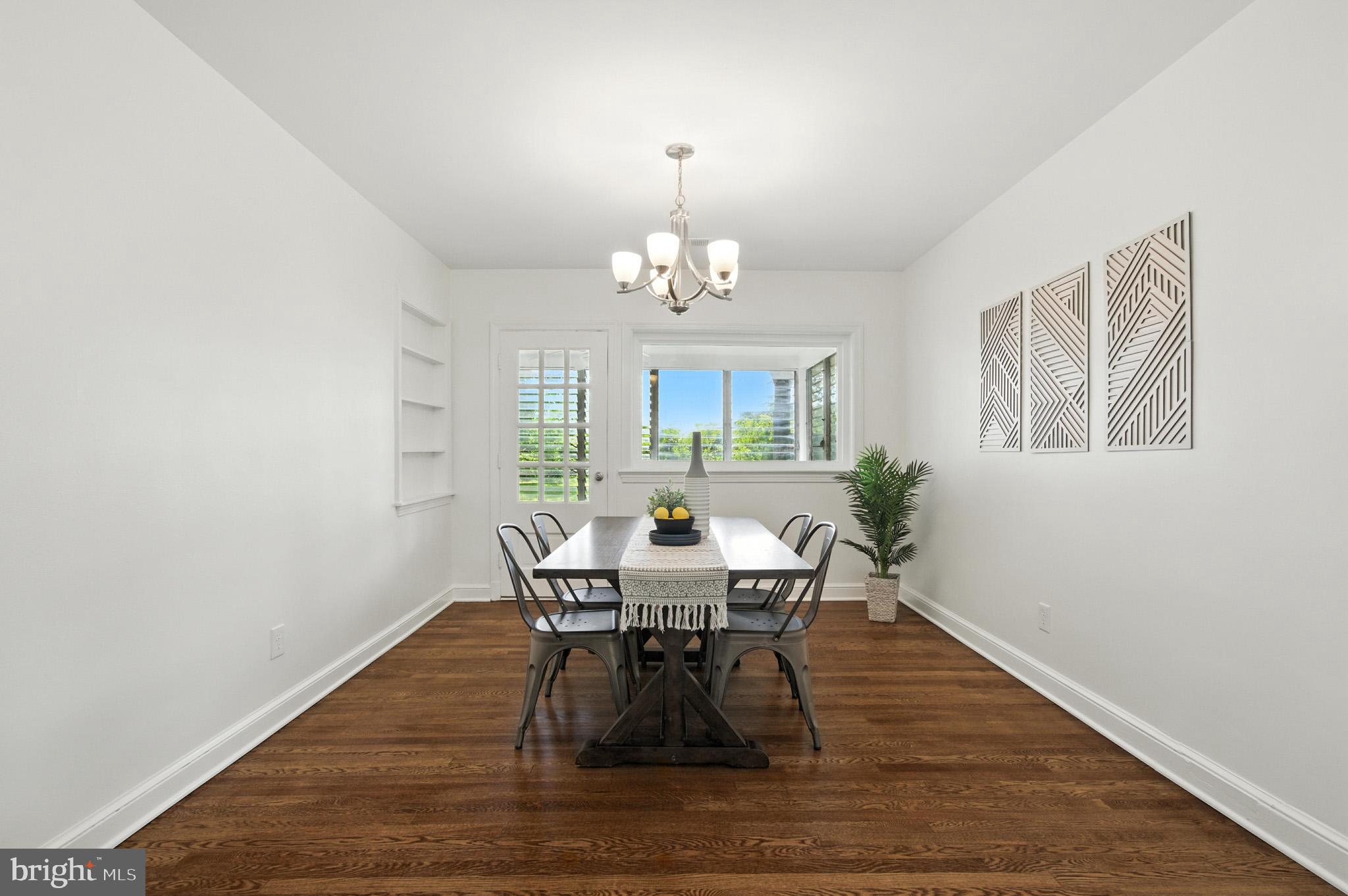 307 Plymouth Street Silver Spring, MD 20901 - Photo 5 of 44 a view of a dining room with furniture a chandelier and wooden floor