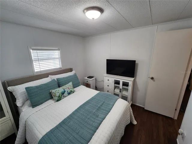 a bedroom with a bed and a mirror