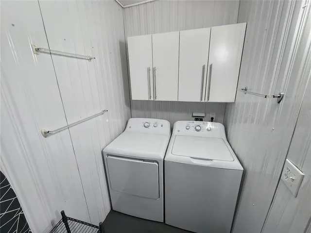 a view of walk in closet with clothes