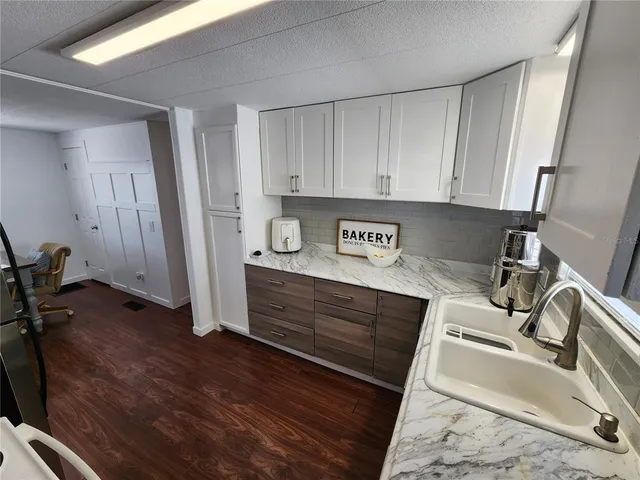 a kitchen with a sink and a stove top oven