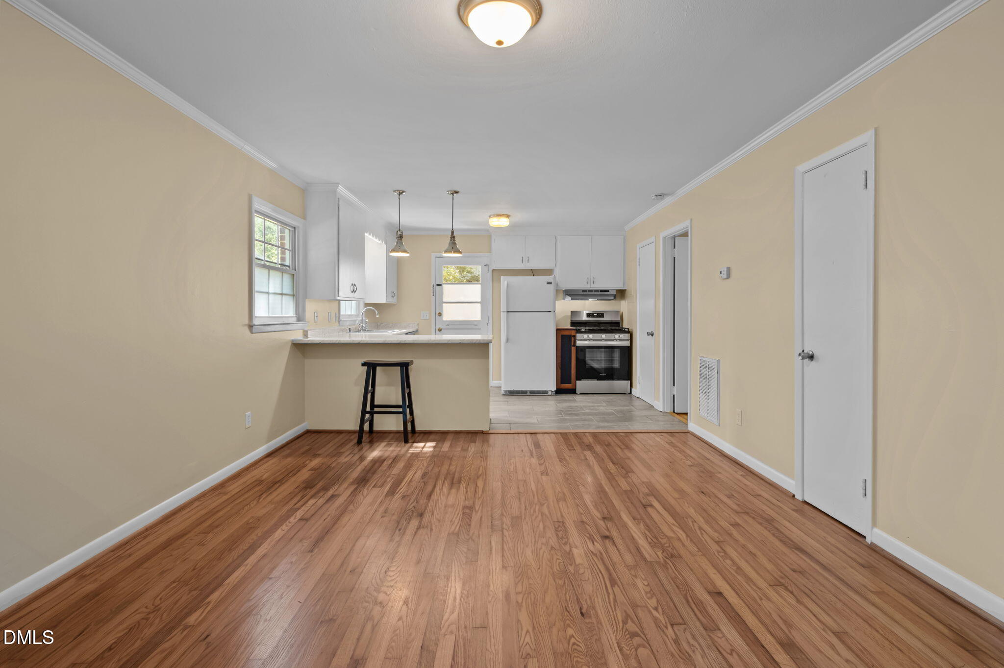 200 Davie Road, Unit A&B Carrboro, NC 27510 - Photo 17 of 36 a view of a kitchen with a fridge wooden floor and a window